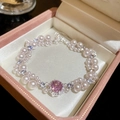 Detailed close-up of a luxury pearl bracelet with a pink gemstone in a pink gift box - Style 35 (Pink)