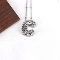 Detailed view of silver necklace with geometric textured letter C pendant on a chain - Letter C