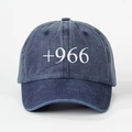 Detailed view of the 3D white +966 embroidery on the washed navy denim baseball cap - Dark Blue