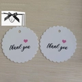 White round wavy gift tag with black thank you text and pink heart on wood background - Thank You Tag / 32x25x11cm / Gift Tag