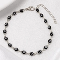 Close-up of silver chain bracelet with black evil eye beads and adjustable lobster clasp - Silver Base Black