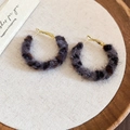 Detail of round leopard print faux fur earrings with gold hooks on a minimalist tray - Silver Earring Post - Grey