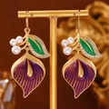 Elegant purple calla lily earrings with white pearls and gold accents on a display - Purple Calla Lily Style (A-1295)