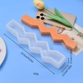 Detail view of zigzag silicone mold and orange candle with dimensions 23.5x3.7x3.1cm - Zigzag Shape (3)