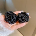Detailed view of hand-held 3D fabric flower earrings in black with elegant petals - Black Flower Style (75#)