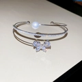 Detail of silver bangle with zircon butterfly, pearls, and sparkling double-layer design - Silver-Double Layer Butterfly (HB4664)
