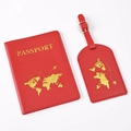 Macro detail of red faux leather passport cover and luggage tag with gold foil world map - Red Map