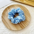 Blue and white gingham checkered fabric scrunchie displayed on a minimalist wooden tray - Dark Blue Grid