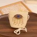 Kids beige straw crossbody bag with sparkling evil eye design and rhinestone fringes - Kids / Beige
