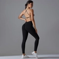 Detail view of seamless cross back sports bra and high waisted black yoga leggings set - S / Black