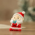 Miniature resin Santa Claus figurine holding a blue gift box for Christmas decor - Santa Claus