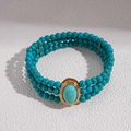 Detailed close-up of bohemian triple-layer turquoise beaded necklace with golden oval centerpiece - Bracelet - Blue (WB1505)