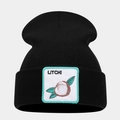 Detailed close-up of a black knit beanie with a square embroidered litchi fruit patch - Litchi Pattern