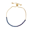 Detailed view of adjustable gold slider bracelet featuring micro-set blue zircon gemstones - Blue