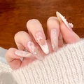 Pink bow press-on nails with white dots and glitter crystal chain on long stiletto shape - M