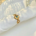 Detailed macro view of vintage gold sunburst ring with blue stone on silk fabric - Adjustable Open / Gold with Blue Zircon