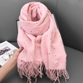 Pink knitted scarf with colorful polka dots and fringe tassels on a grey sofa - 68-180CM / Sakura Pink
