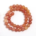Macro detail of orange dragon-vein glass beads with cracked texture for DIY jewelry - Orange Yellow Two-tone Floral Round Bead
