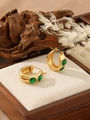 Close-up of gold hoop earrings with green rectangular zircon in elegant setting - ZHE986 Style - Green Rhinestone / 18K Gold