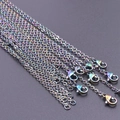 Detailed macro view of multi-colored rainbow stainless steel link chains with lobster clasps - Colorful