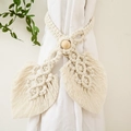 Detailed macro of a handmade boho curtain tieback with cotton leaf design and wood bead - Double Leaf Style / Off White