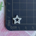 Macro view of a white pearlized star charm for DIY hair accessories on a cutting mat - Pentagram