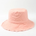 Detailed view of frayed edges on a light pink cotton canvas bucket hat for women - Dusky Pink