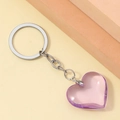 Detail view of a glossy purple 3D resin heart pendant with silver metal keychain ring - Purple