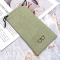 Grass green linen drawstring pouch for sunglasses on a stylish marble surface - Green
