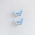 Detailed macro view of two light blue matte butterfly-shaped hollow metal BB hair clips - Matte Butterfly / Blue