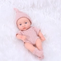 Lifelike 20cm reborn baby doll in pink knit outfit on soft white fur background - Lotus Root Pink Sweater