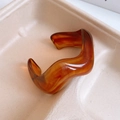 Detail view of wavy resin bangle featuring amber tortoise shell texture in caramel tones - 27# Caramel Wave Amber (27# Bracelet - Amber Color)
