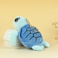 Blue plush sea turtle keychain featuring soft fabric and detailed shell embroidery - Blue