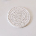 Handwoven round white cotton rope coaster with heat-resistant spiral braided texture - White