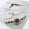 Detail of flower-shaped quartz watch with crystal inlay and adjustable drawstring chain - Rose Gold Black