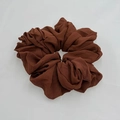 Detail of a brown chiffon hair scrunchie showing soft textured fabric and elastic pleats - Brown (6-3)