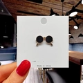 Detailed view of a round black enamel sunglasses brooch with gold trim on a display card - 8*Sunglasses Eye Pin