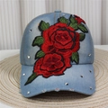 Close-up of denim baseball cap featuring red rose embroidery and silver metal rivets - Style 3-Light Blue Denim Rose Studded