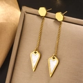 Detailed shot of long gold tassel earrings with heart-shaped shell pendants and fine chains - Gold E-404 (Tassel Mother of Pearl Heart)