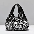 Fashionable leopard print handbag with black handles and silver hardware finish - Leopard Print