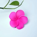 Pink plumeria foam hair clip shown on light blue background with green leaves - Pure Rose-red Flower Head [4cm]