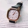 Close-up of a vintage square quartz watch with black leather strap and rose gold metal case - Black