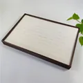 Detail view of the 100-slot rectangular wooden jewelry display tray with white velvet lining - Brown + White Brushed Leather
