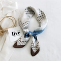 Elegant blue and coffee geometric silk scarf tied on a white shirt in a French style - New Grid Brown Edge