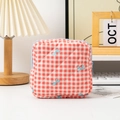 Detailed view of quilted red and white checkered makeup bag with blue bow patterns - Plaid Red Bow