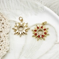Detail of sunflower charms with red and white enamel in a ceramic dish with feathers - Red Enamel Sun