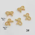 Macro detail of 6mm x 4mm gold bow-shaped alloy nail art charms with spiral texture - Textured Bow Style (3#)