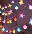 Solar outdoor LED string lights with multicolor star and frosted globe bulb design - Stars + Colorful Small Spheres