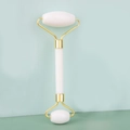 Close-up of dual-head white jade roller with gold metal brackets for facial massage - Double Head Jade Roller White Jade