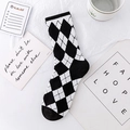 Flat lay of black and white checkerboard crew sock with trendy ins style lifestyle props - Black White Argyle (No. 05)